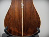 A small nouveau inlay on the back of a Brazilian rosewood guitar back.