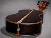 This Brazilian rosewood tenor ukulelehas a striking white sapwood stripe down the center.