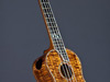 Long neck concert ukulele with hibiscus inlay.
