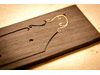 Here is the bamboo inlay being seated into the channel of the fretboard